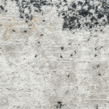 Soft ivory shag rug with cream tones and charcoal speckles, plush pile ideal for living room or bedroom decor.