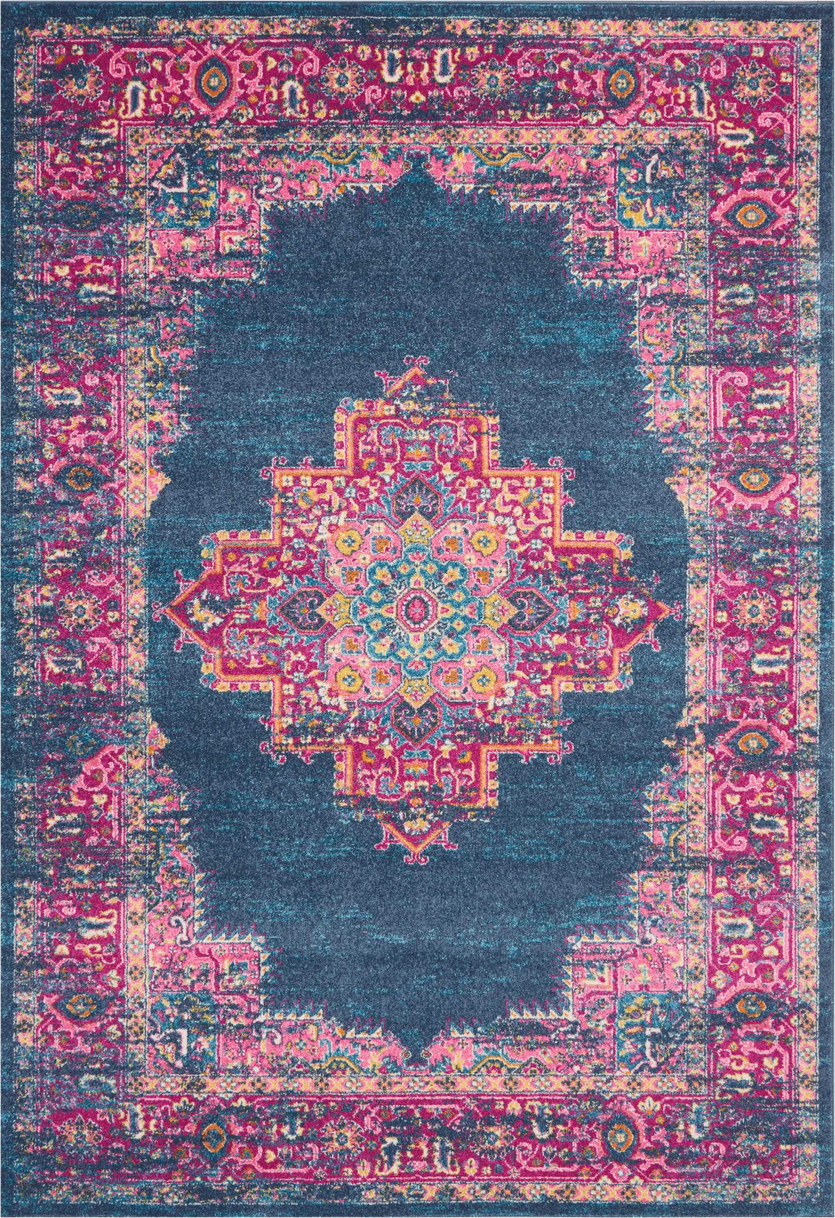 Distressed Persian-inspired area rug with teal navy field, pink ornate border and colorful central medallion.