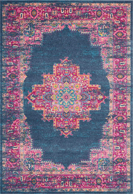 Distressed Persian-inspired area rug with teal navy field, pink ornate border and colorful central medallion.