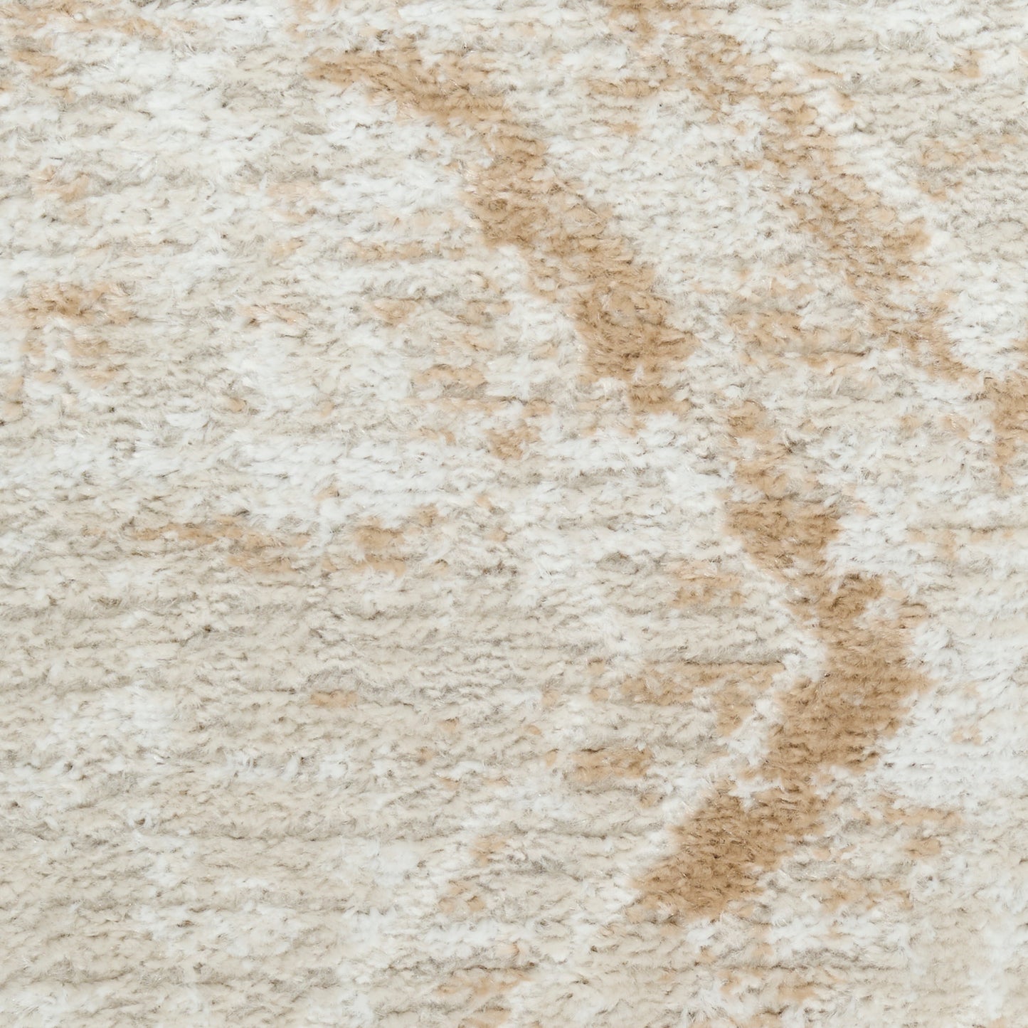 Beige shag rug with cream and tan abstract leaf pattern; plush, tufted pile.
