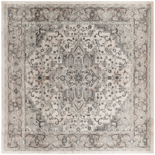 Distressed beige-gray farmhouse-style rug with a central medallion, intricate floral motifs and layered borders.