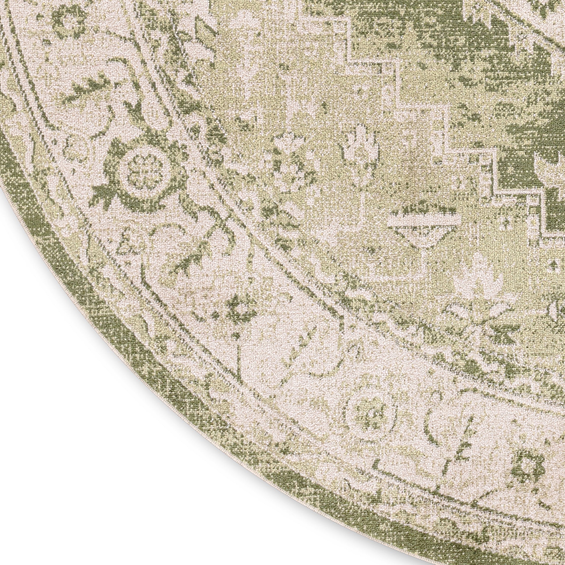 Round area rug with antique-style botanical pattern in muted green and cream.