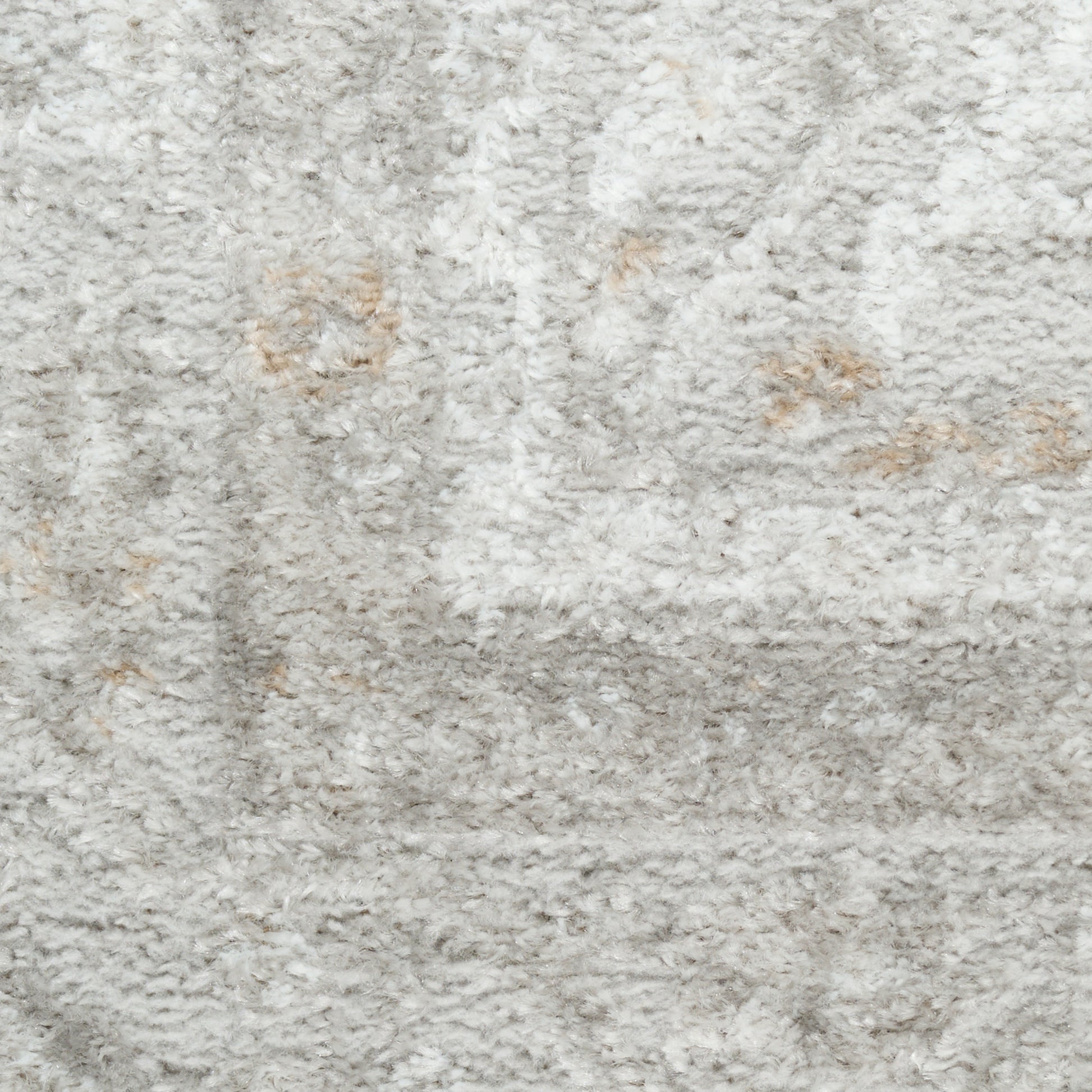 Close-up of light gray shag rug with soft plush pile and subtle beige specks.