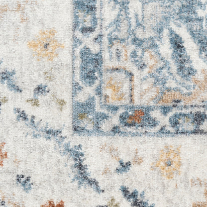 Distressed blue and ivory area rug with floral motifs and pale orange accents.